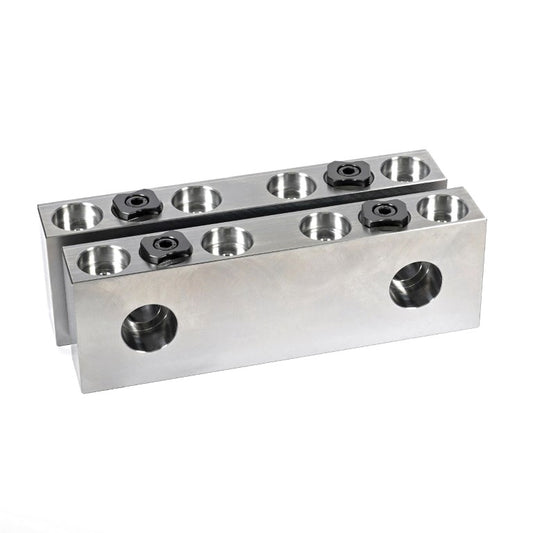 A set of metal round part gripper vice jaws with multiple screw holes, for bolting to a machine vice.