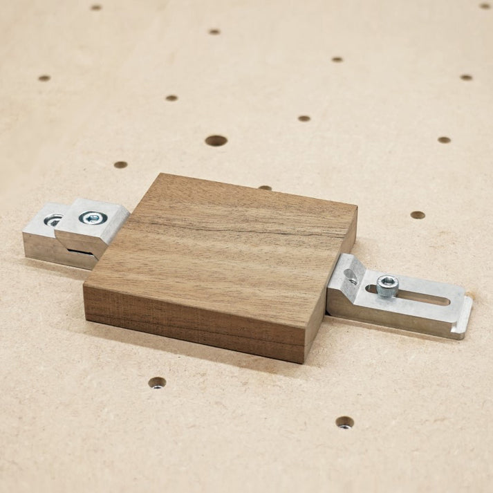 strap clamp and top clamp holding a block of walnut wood