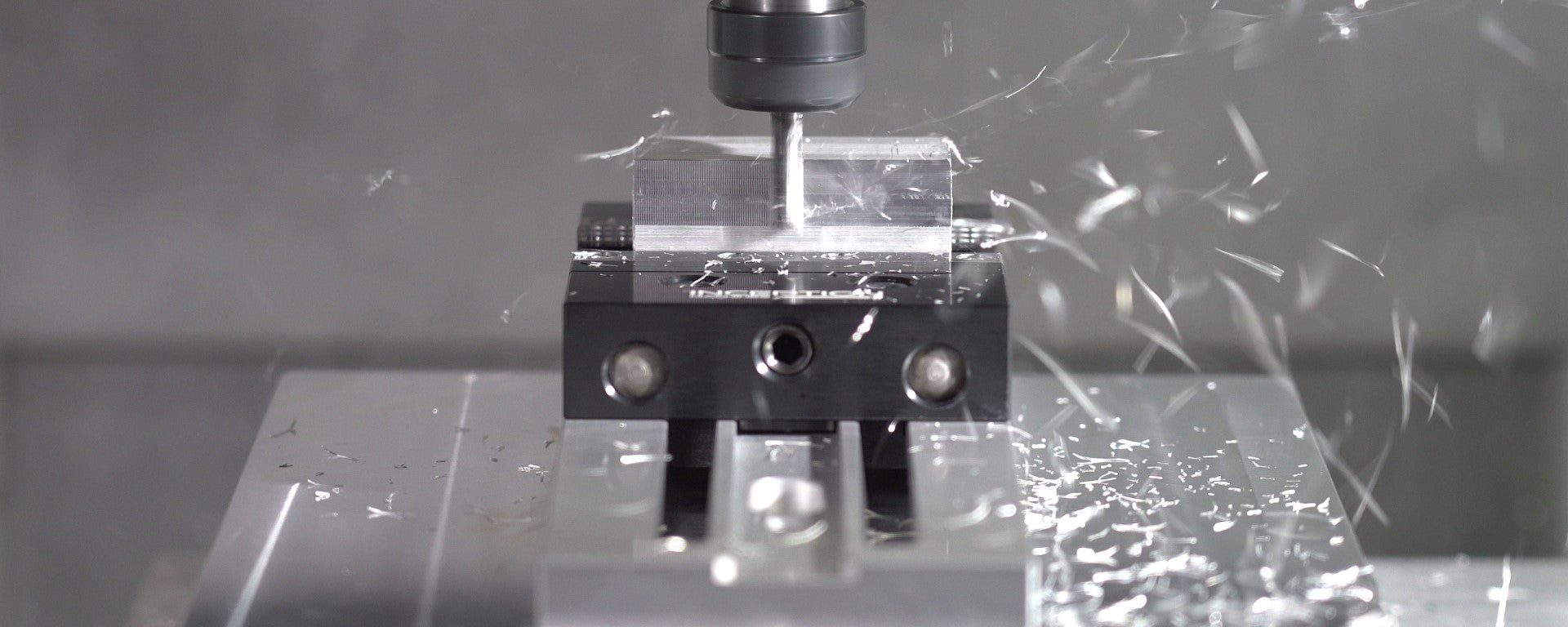 Low Profile Vice holding an aluminium block while being machined