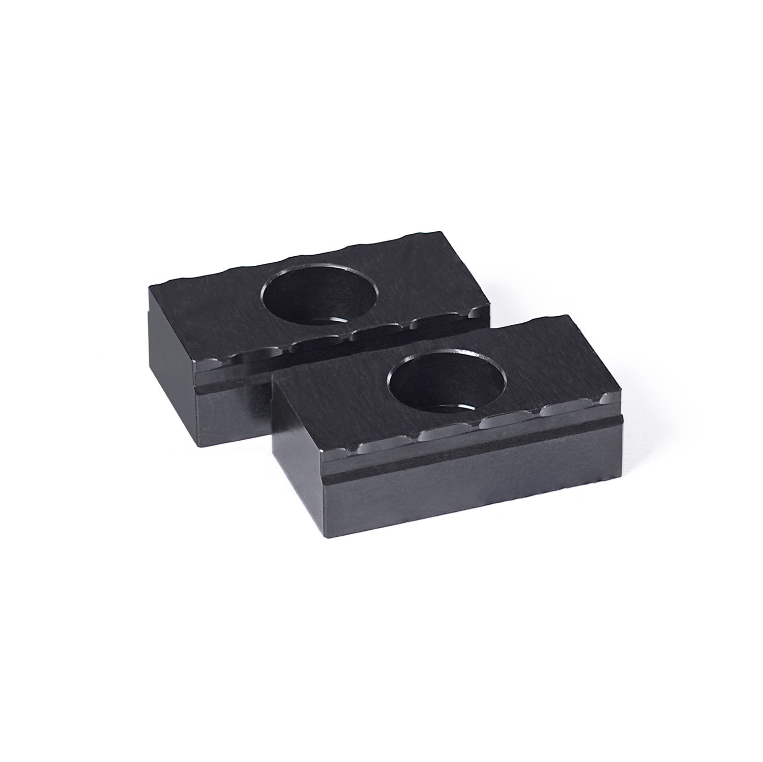 Two 25mm black steel serrated grippers designed for OP1 workholding in CNC machining