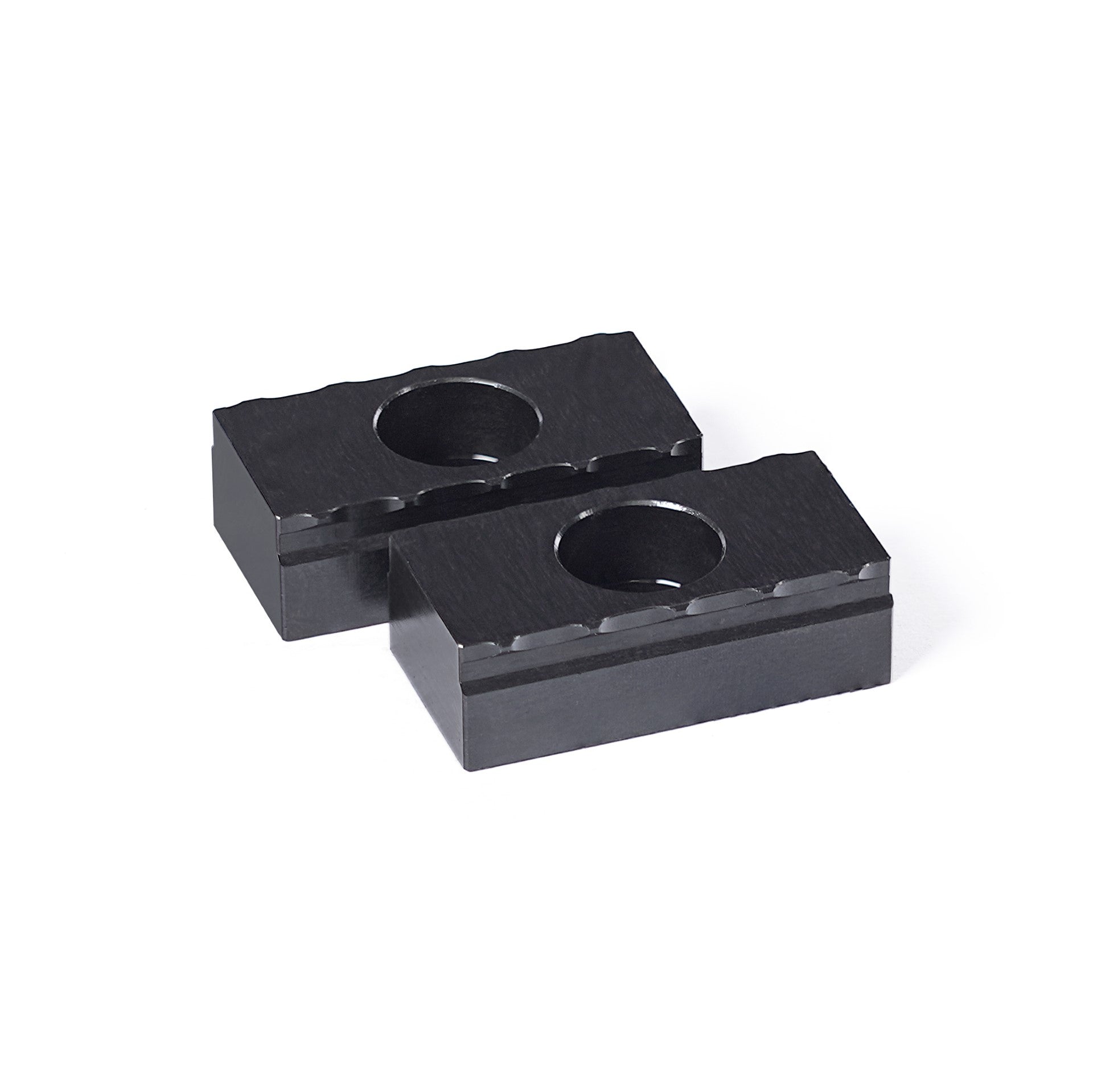 Two 25mm black steel serrated grippers designed for OP1 workholding in CNC machining