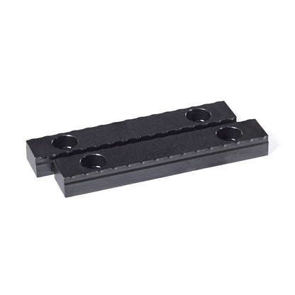 Two 75mm black steel serrated grippers designed for OP1 workholding in CNC machining