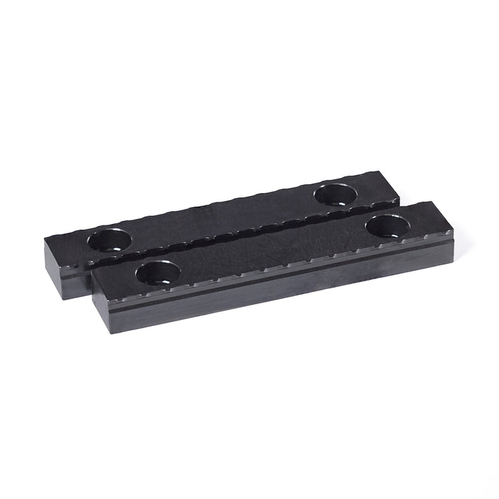 Two 75mm black steel serrated grippers designed for OP1 workholding in CNC machining