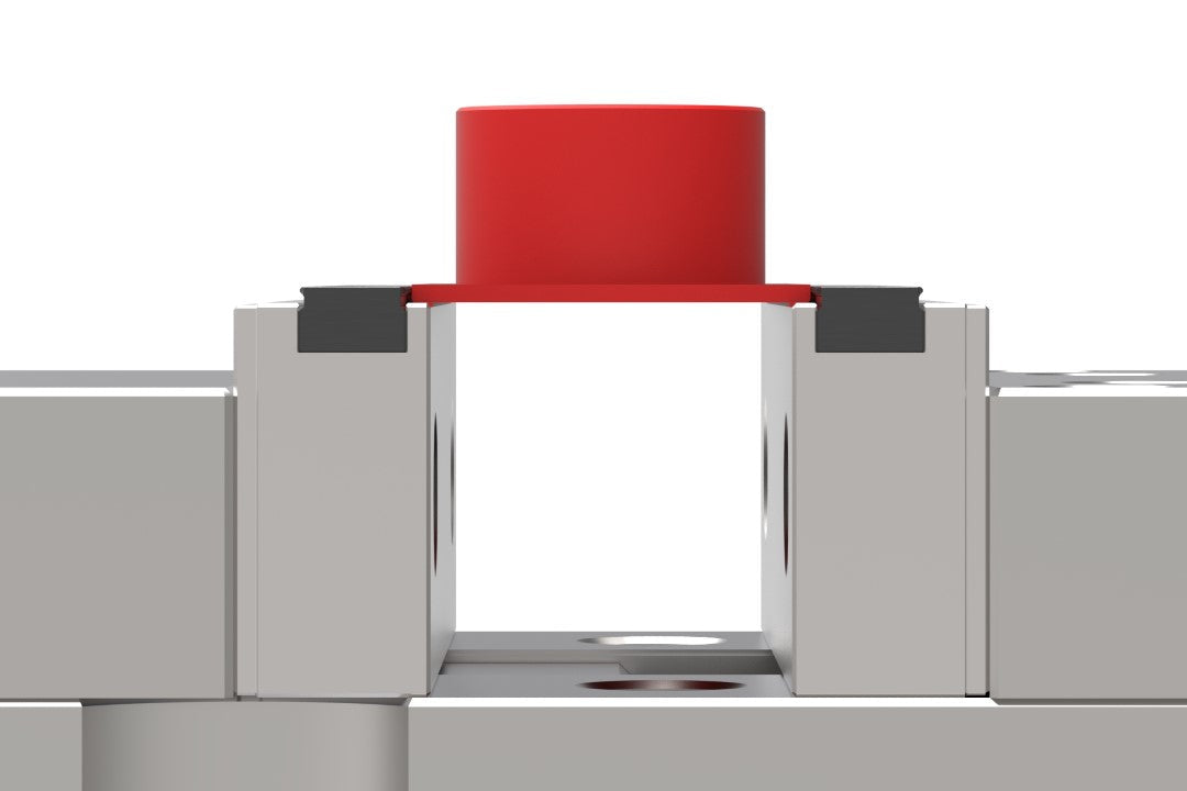 Serrated vice jaws holding a CNC machined part in OP1 by just 2mm of material