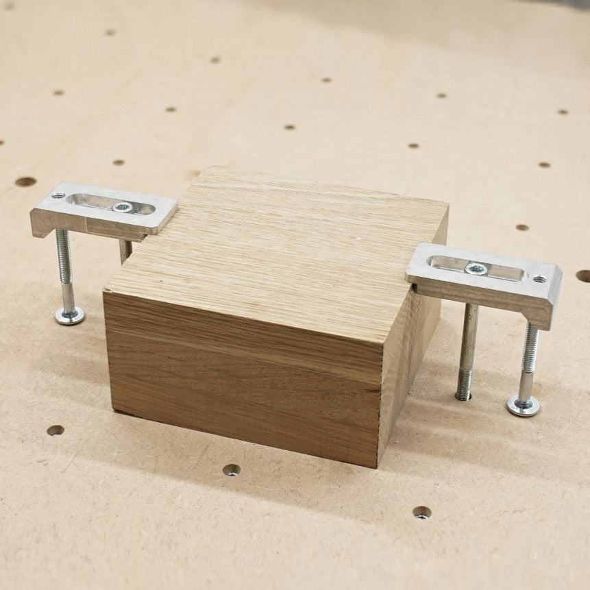 aluminium strap clamps holding a 63mm wooden block