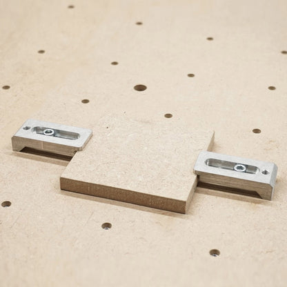 aluminium strap clamps holding a 12mm wooden block